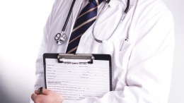 Male Doctor Ready To Write Patient Information